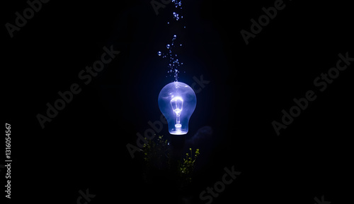 Illuminated Light Bulb with Bubbles in Dark Water