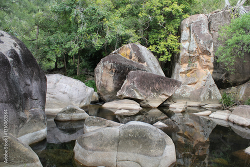Rock pool surrounded by a forest of trees at Jourama Falls in North Queensland, Australia