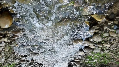 An upside-down view of a cascading waterfall in slow motion