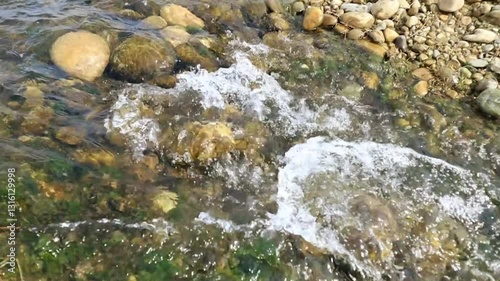 A serene waterfall flowing down the rocks in elegant slow-motion capture