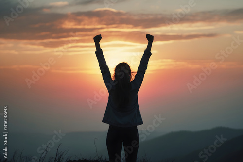 A woman standing alone on a hilltop, raising both hands in joy and triumph.