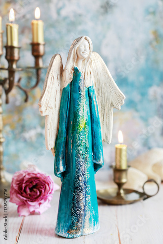 Obraz na płótnie Beautiful blue figurine of an angel on the table. w salonie