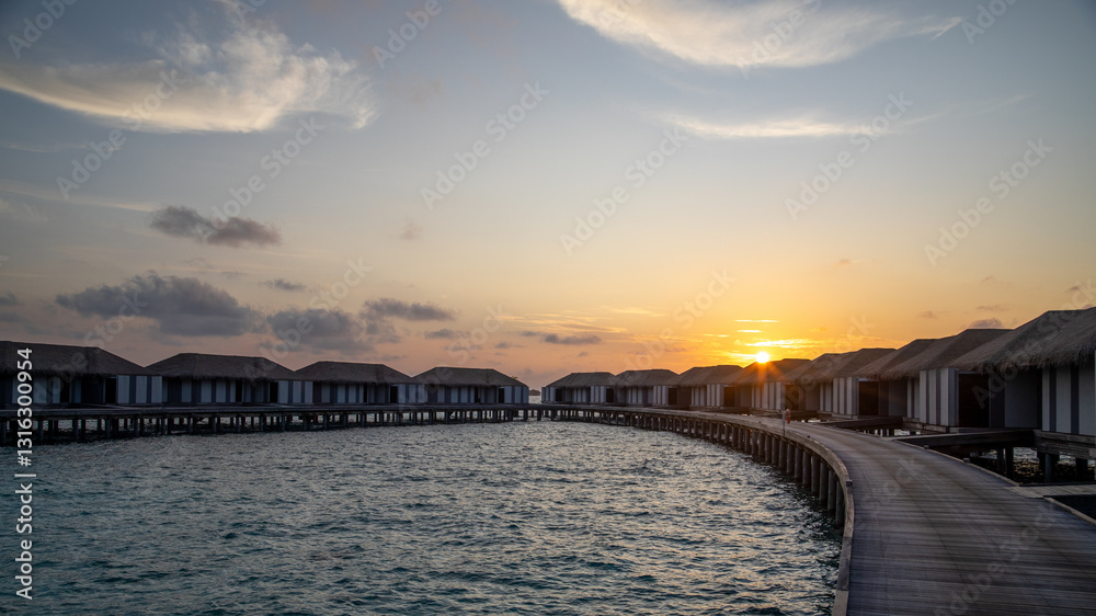 Fototapeta premium Water villas in the Maldives at sunrise