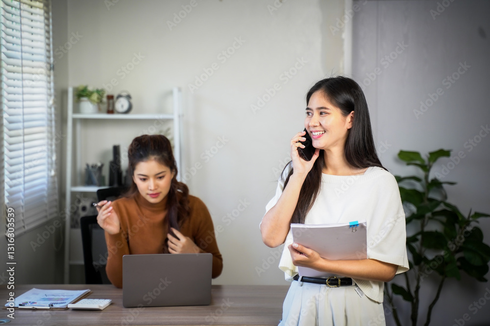 Business team of two executives working together using laptop in office. Happy young business woman manager showing project presentation to mature woman client, investor or partner at work meeting. Business team of two executives working together using laptop in office. Happy young business woman manager showing project presentation to mature woman client, investor or partner at work meeting.