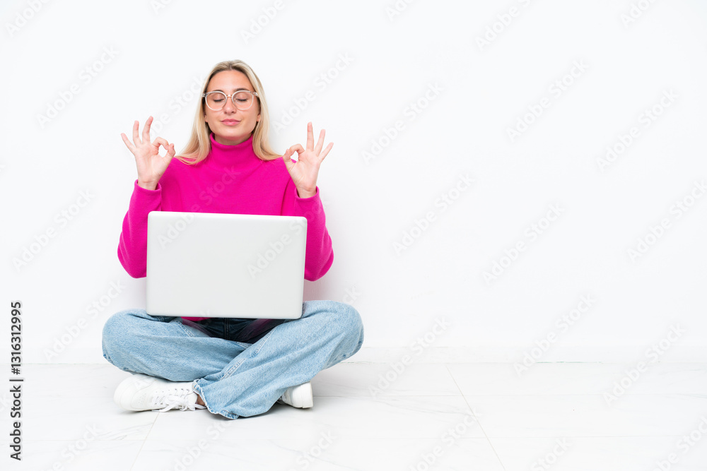 Young caucasian woman with laptop sitting on the floor in zen pose Young caucasian woman with laptop sitting on the floor in zen pose