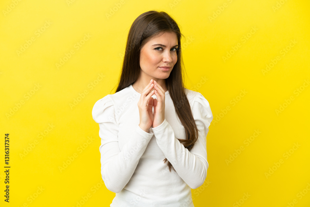 Young caucasian woman isolated on yellow background scheming something Young caucasian woman isolated on yellow background scheming something