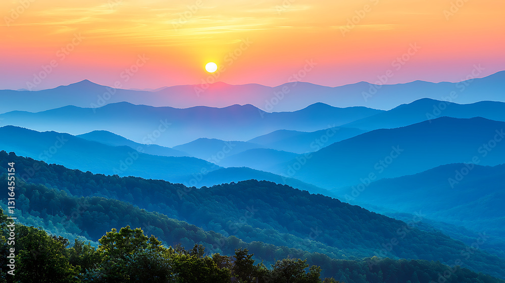 Obraz premium Layered blue mountain range under a bright colorful sunrise sky Trees fill the foreground in the fading light.