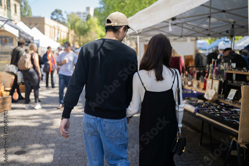 people walking in a street market exploring a city
