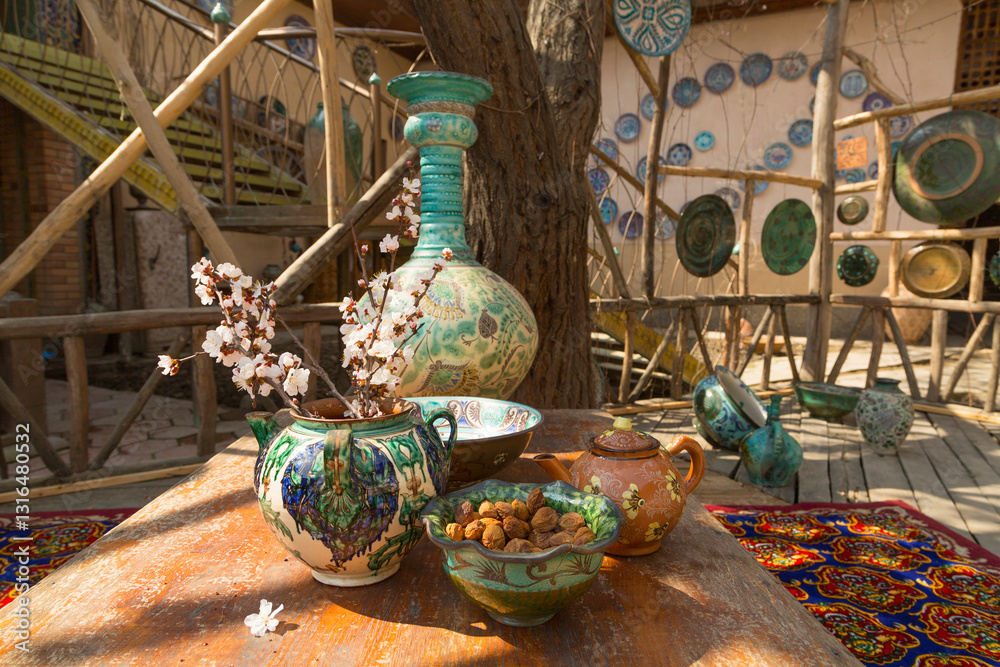 Uzbek traditional dishes, a branch of flowering almonds and a dish with dried apricots in the yard