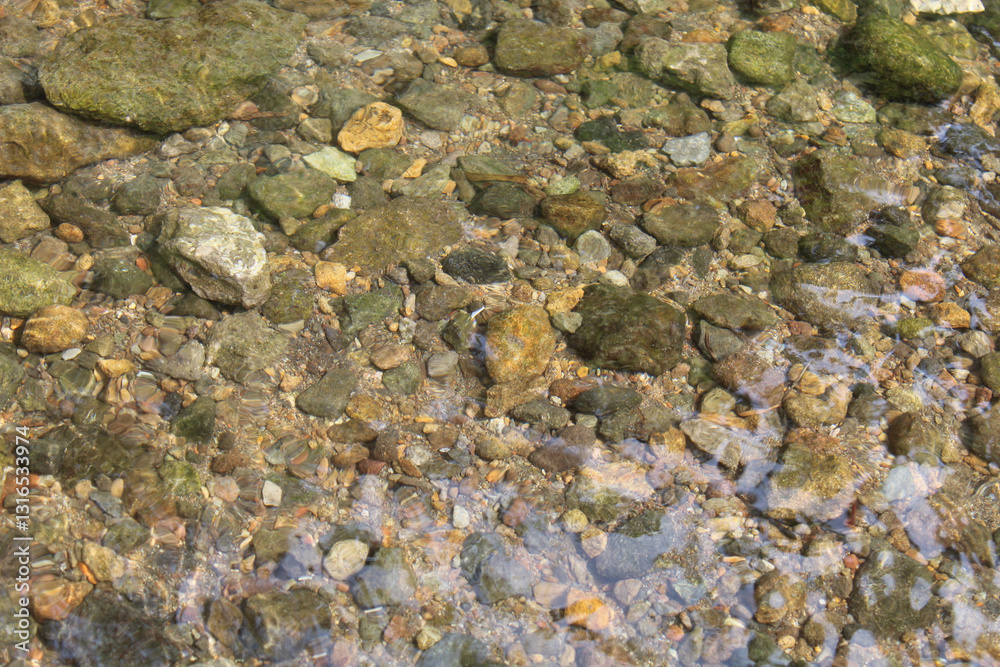Clear water flow over rocky bottom river Clear water flow over rocky bottom river