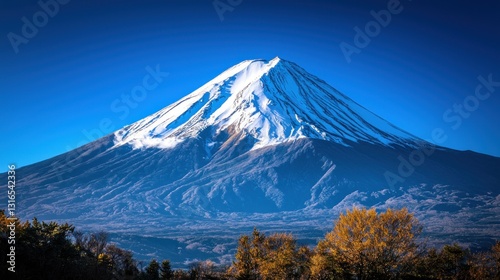 Majestic snow-capped mountain peak against a vibrant blue sky.