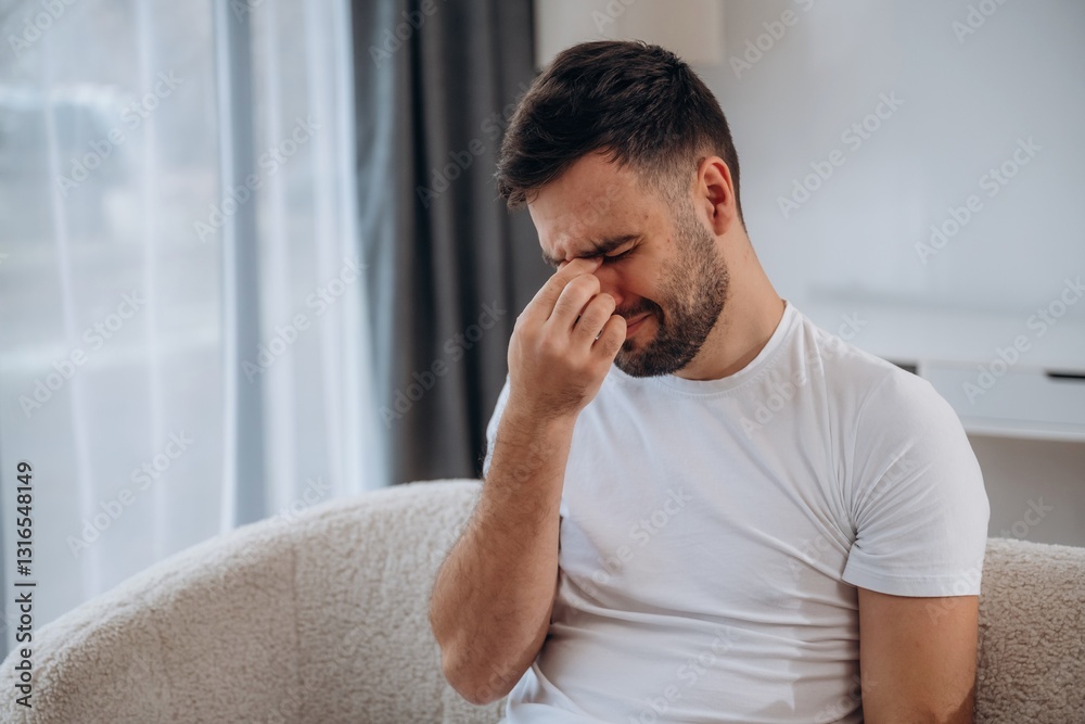 Terrible headache. Sick man is feeling bad at home