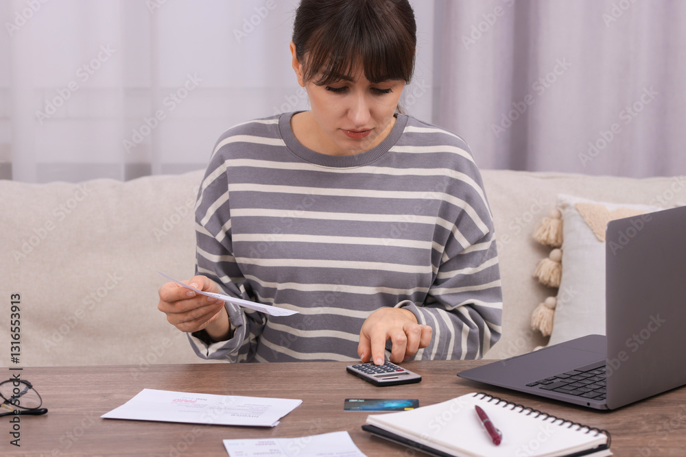 Paying bills. Woman with different invoices and calculator at wooden table indoors Paying bills. Woman with different invoices and calculator at wooden table indoors