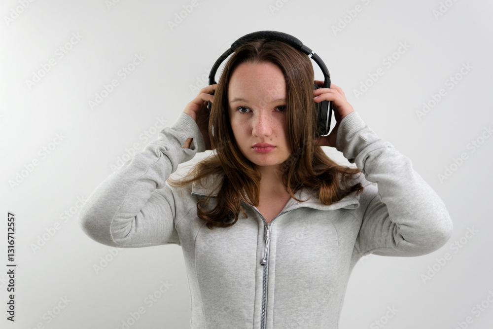 young teenage girl in sporty gray sweater different emotions facial expressions loose brown hair on white background young teenage girl in sporty gray sweater different emotions facial expressions loose brown hair on white background