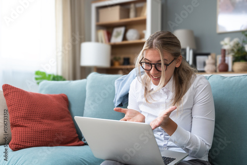Young cozy relaxed self loved business woman talking online with psychotherapist on video call, say thank you for helping her. Relaxed female in her comfort zone telecommunicating with her accountant.