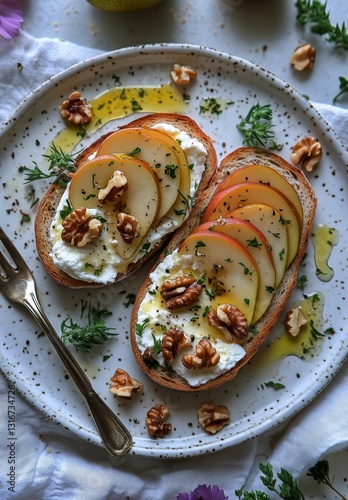 Sliced Pear and Walnut Toast on Whole Grain Bread With Herb Garnish for a Hea...