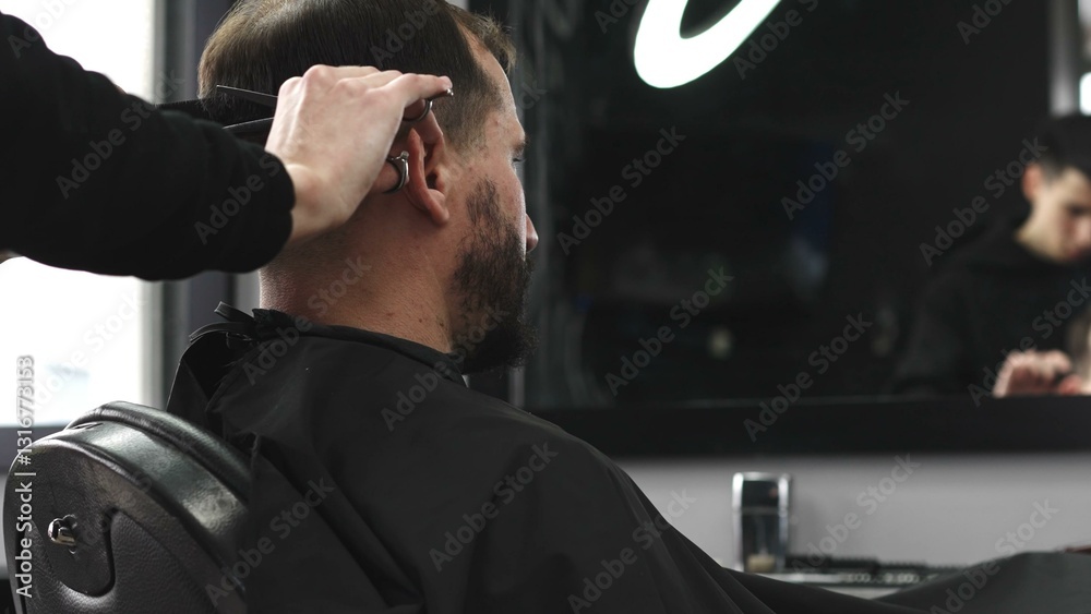 Skilled barber trimming client's hair using professional scissors, creating precise hairstyle in contemporary salon with modern interior and relaxed atmosphere, closeup