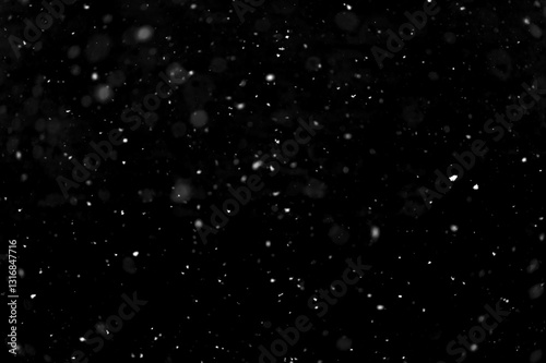 Texture of natural falling snow on black background.