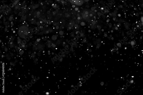 Texture of natural falling snow on black background.