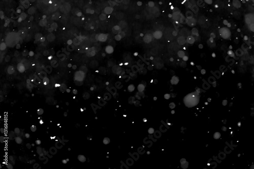 Texture of natural falling snow on black background.