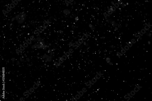 Texture of natural falling snow on black background.