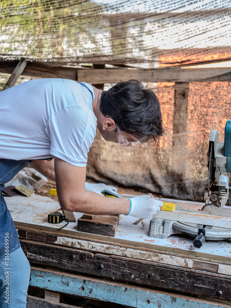 Carpenter working on woodworking use cartridge meter measuring in carpentry shop.