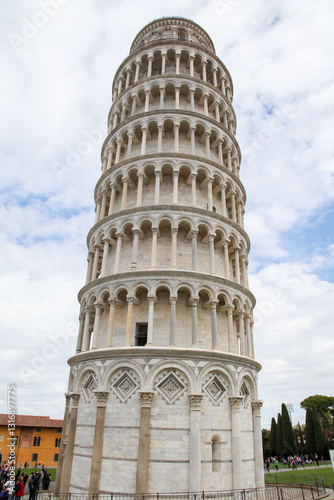A tall white Pisa tower with a clock on top in Pisa Italy Toscana