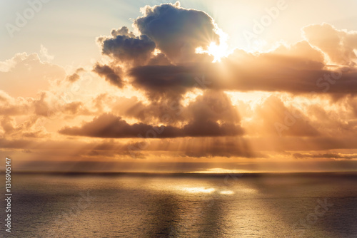 cloud in a form of flying sauser with light and shadows in amazing sunrise or sunset sky above water in beautisul seascape photo