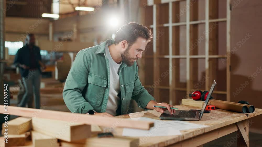 Carpentry, documents and man in workshop on laptop for online orders, furniture and manufacturing. Factory, construction and person on computer for lumber, timber inventory and woodworking production Carpentry, documents and man in workshop on laptop for online orders, furniture and manufacturing. Factory, construction and person on computer for lumber, timber inventory and woodworking production