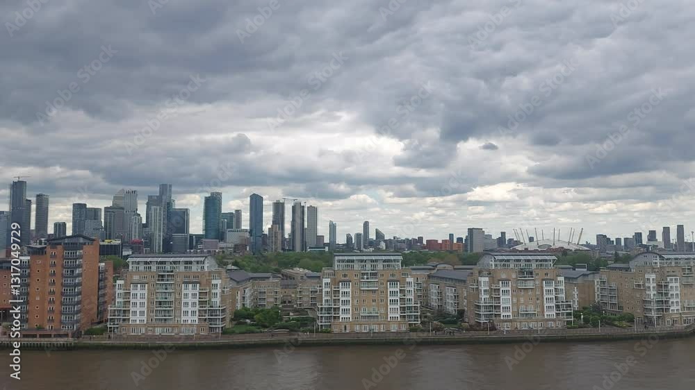 Cloudy Urban Skyline Over River in Modern Cityscape Cloudy Urban Skyline Over River in Modern Cityscape