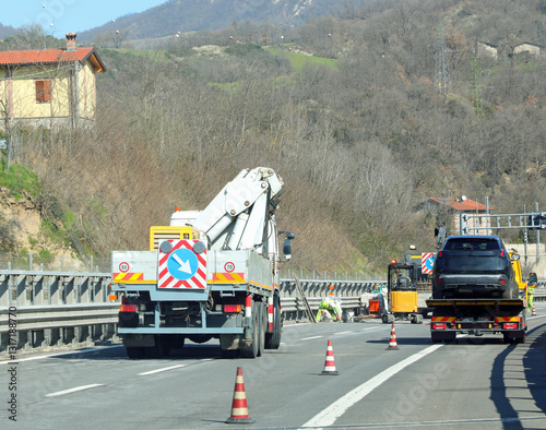 фотографія Reduced width lane on the highway and viaduct maintenance work and a tow truck c