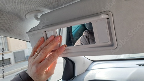 Hand holding Car sun visor.