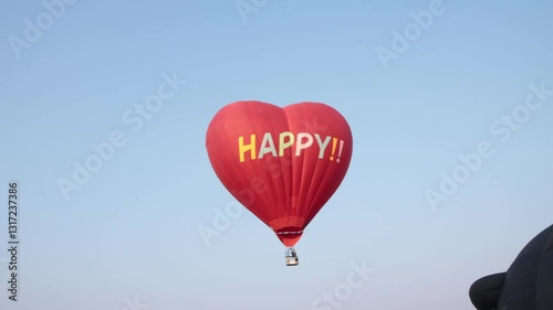 Handheld Red Heart Shape Hot Air Balloon on Sky Background. Funny Balloon Festival Activity