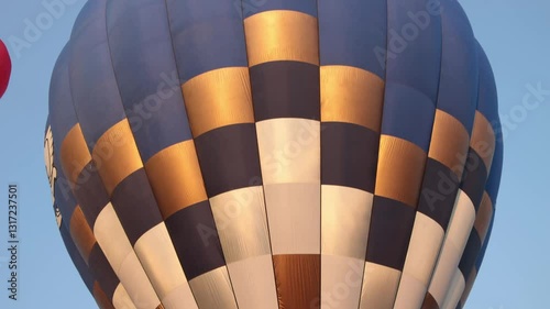 Tilt Handheld Blue Gold Hot Air Balloon on Sky Background. Funny Balloon Festival Activity