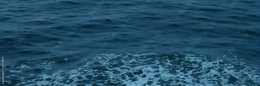 Fototapeta premium Ocean's Embrace: Capturing the movement of the sea, this image portrays the raw power and endless allure of the ocean, as waves crash in a seamless display of nature's artistry.