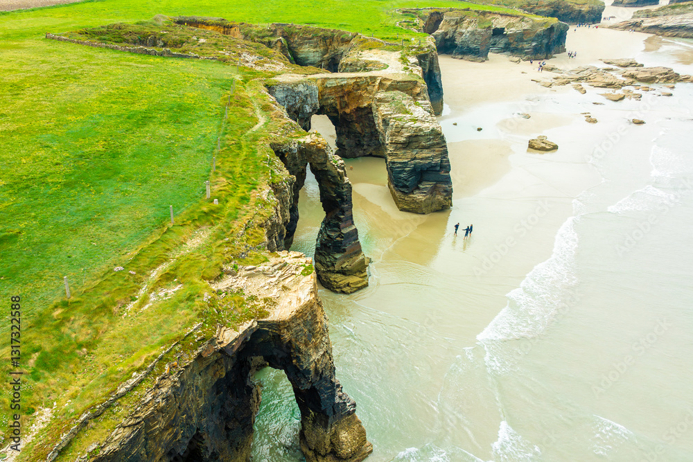 Natural rock arches Cathedrals beach, Playa de las Catedrales at Ribadeo, Galicia, Spain. Famous beach in Northern Spain Atlantic. Natural rock arch on Cathedrals beach in low tide