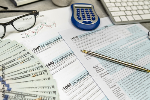 tax form 1040 with dollars calculator, pen on desk. Tax Day concept. Tax Return, business finance photo