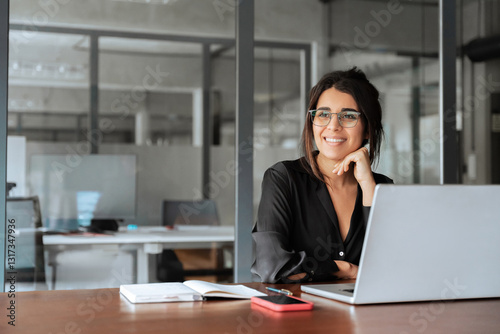 Portrait of smiling latin hispanic middle-aged business woman work on laptop computer in modern office. Indian young businesswoman professional employee using pc, looking dreaming aside. Copy space