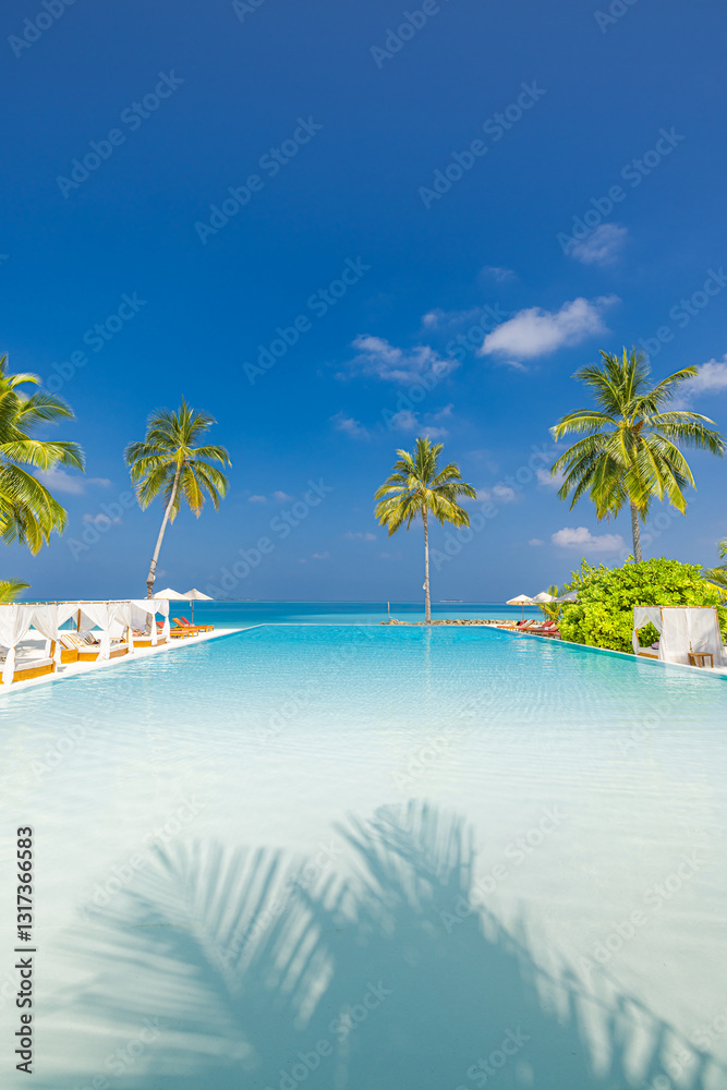 Fototapeta premium Panoramic tourism landscape. Luxury poolside beach resort hotel swimming pool lounge chairs beds umbrellas palm trees, relax lifestyle blue sky sunshine. Summer tropics island, leisure travel vacation