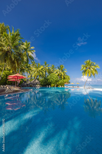 Stunning landscape, swimming pool blue sky with clouds. Tropical resort hotel in Maldives. Fantastic relax water peaceful vibes, chairs, loungers under umbrella and palm leaves. Luxury travel vacation