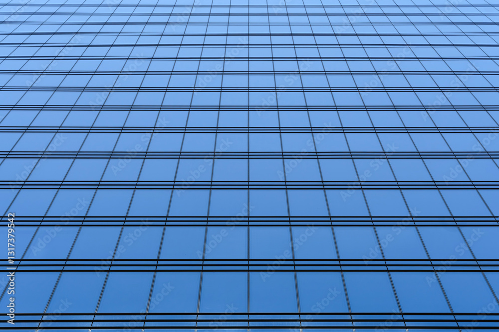 Fragment of a modern high-rise with glass walls. Beautiful blue background Fragment of a modern high-rise with glass walls. Beautiful blue background