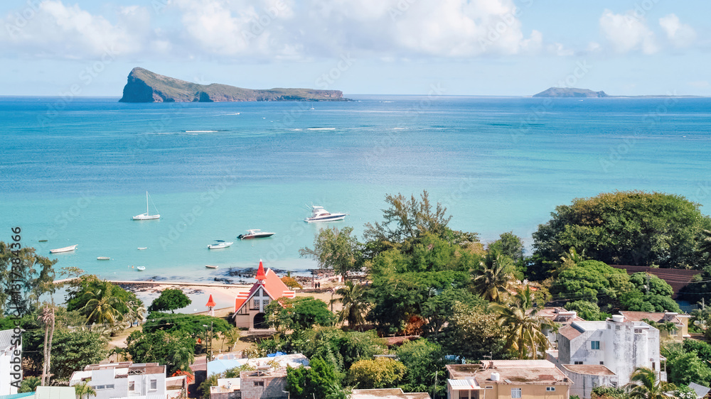 Obraz premium Stunning aerial view of Gunner's Quoin (Coin de Mire) Island and the iconic red-roofed church on the beach at Cap Malheureux, Mauritius