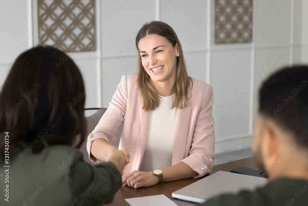 Female applicant shaking hands HR manager across table, getting hired, feels satisfied with job interview. Business professionals establish partnership, making deal, handshaking express mutual respect Female applicant shaking hands HR manager across table, getting hired, feels satisfied with job interview. Business professionals establish partnership, making deal, handshaking express mutual respect