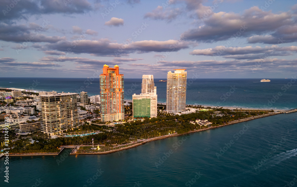 Fototapeta premium Skyline panorama. Sea beach. Miami South beach landscape aerial view. Skyline aerial on Miami marina, Florida. Aerial Miami south beach with sunset. Marina landscape in South Beach. Miami skyline