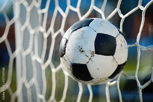 Soccer ball in soccer goal net . Close-up textured soccer net on soccer goal in big stadium.