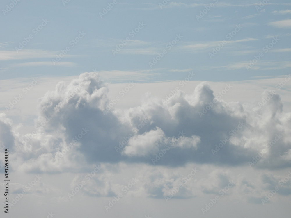 Fototapeta premium Clouds forming within a blue sky. Cloudscape over Galloway, New Jersey.