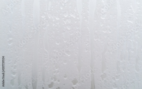 Water Droplets Forming Vertical Streaks on Window Pane