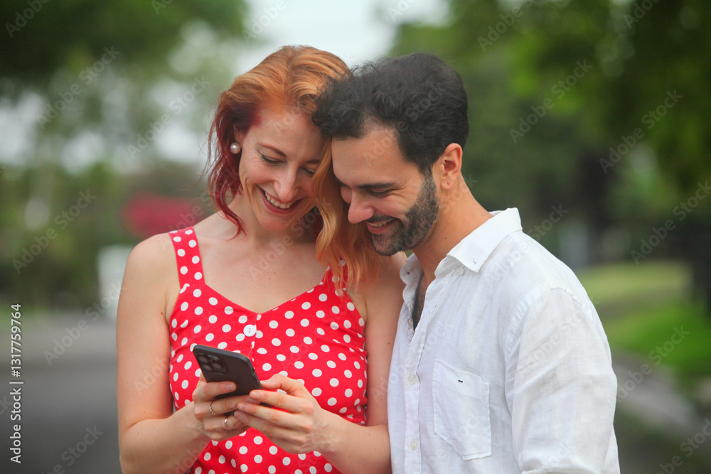 portrait of cheerful young couple in love using smartphone outdoors smiling portrait of cheerful young couple in love using smartphone outdoors smiling