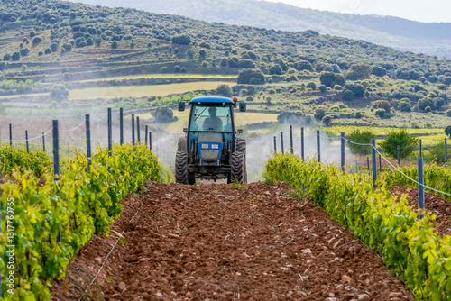 tractor spraying vineyards with chemicals