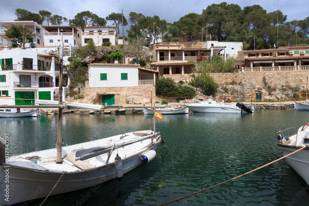 Europe, Spain, Balearic Islands, Mallorca, Santanyi, Cala Figuera . A small , colorful fishing harbor on S.E. corner of island. Sailboat anchoring. 2017-04-16